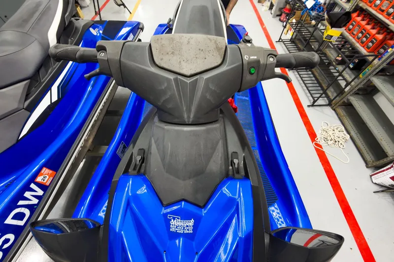 Slide: The Image of 2018 Yamaha WaveRunner EX Deluxe in a workshop, showcasing handlebars and vibrant blue design. - 16
