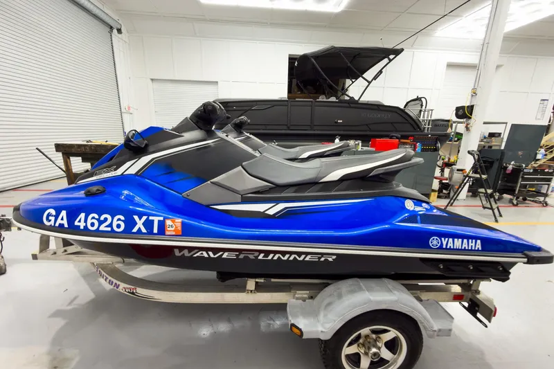 Slide: The Image of 2018 Yamaha WaveRunner EX Deluxe in a garage, blue and black, on a trailer. - 2