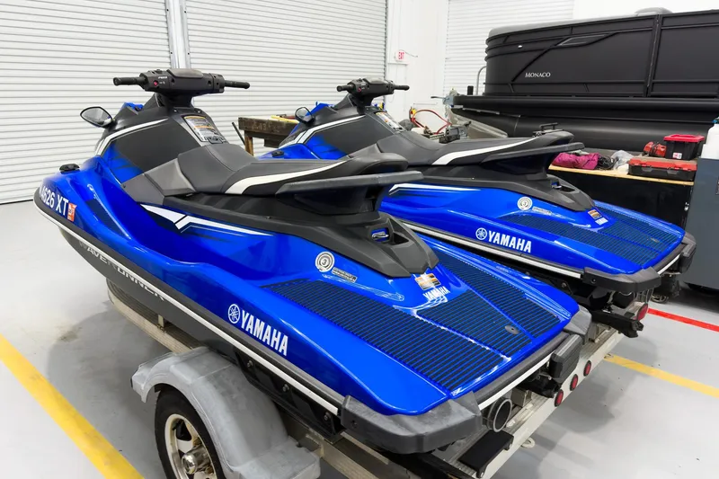 Slide: The Image of 2018 Yamaha WaveRunner EX Deluxe jet skis in a garage setting. - 3
