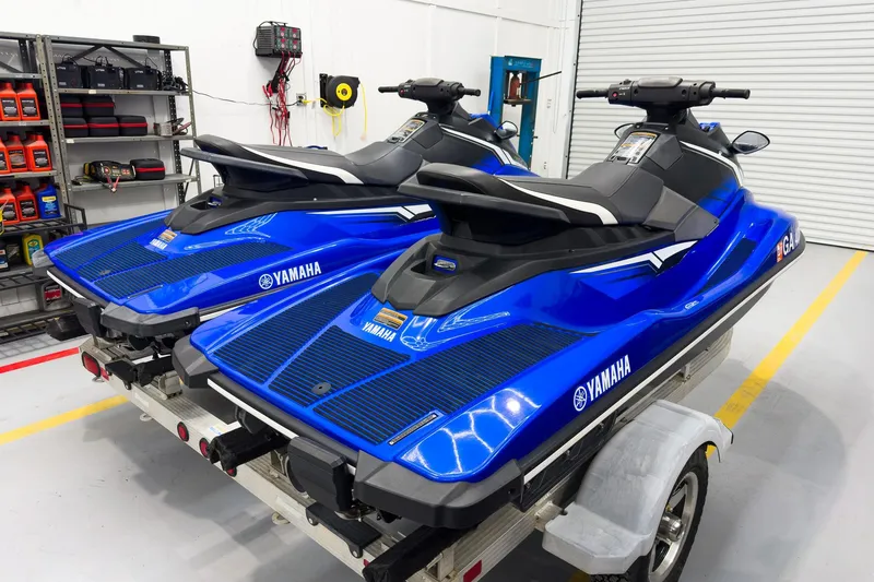 Slide: The Image of 2018 Yamaha WaveRunner EX Deluxe jet skis in a garage on a trailer. - 5