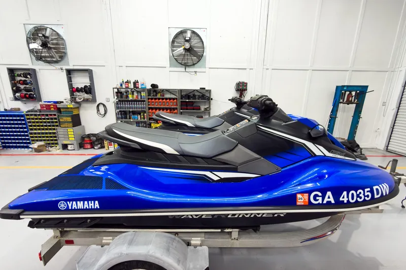 Slide: The Image of 2018 Yamaha WaveRunner EX Deluxe in a workshop setting, blue color, on a trailer. - 6