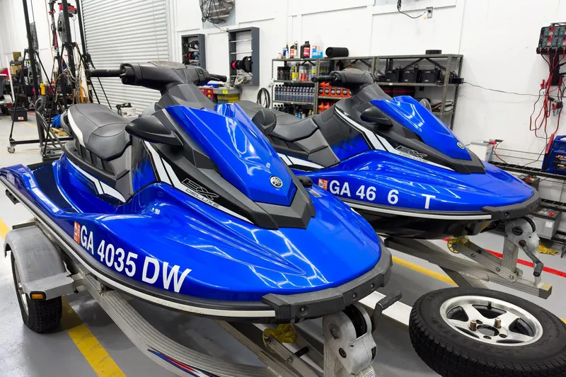 Slide: The Image of 2018 Yamaha WaveRunner EX Deluxe jet skis in a workshop setting. - 7