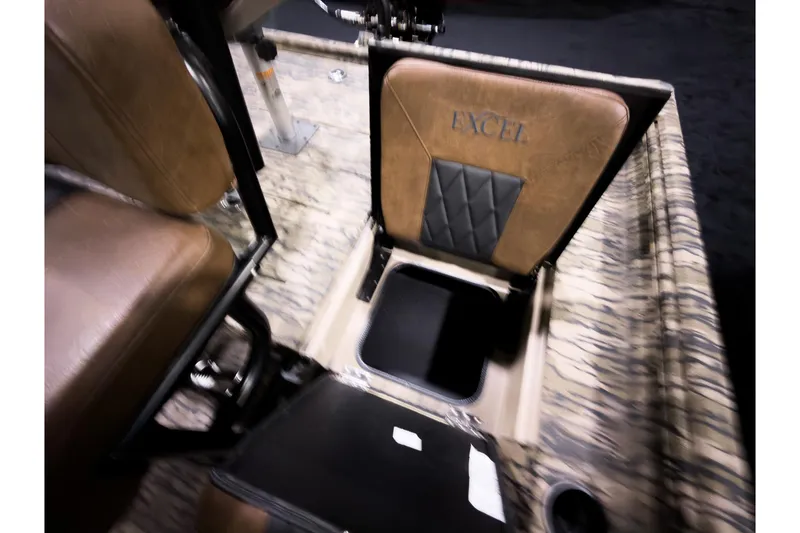 Slide: The Image of 2026 Excel 220 Bay Pro Elite boat interior with open storage compartment and cushioned seating. - 10