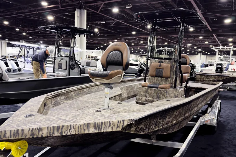 Slide: The Image of 2026 Excel 220 Bay Pro Elite boat on display at an indoor exhibition. - 3