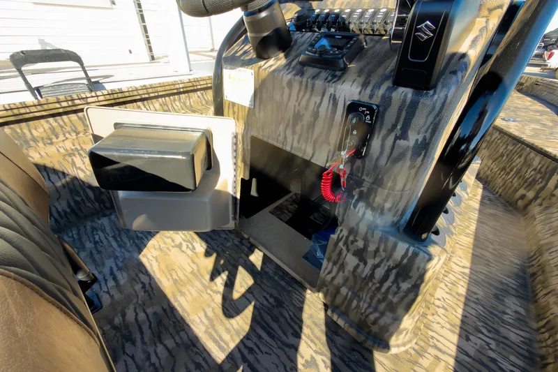Slide: The Image of 2026 Excel Bay Pro Elite 220 boat interior with camo design and control panel. - 36