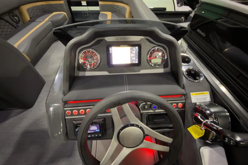 Slide: The Image of Dashboard of 2026 Godfrey Monaco 255 Ultra Lounge boat with modern controls and steering wheel. - 14