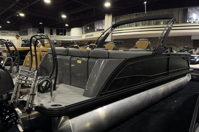 Slide: The Image of 2026 Godfrey Monaco 255 Ultra Lounge pontoon boat displayed indoors. - 2
