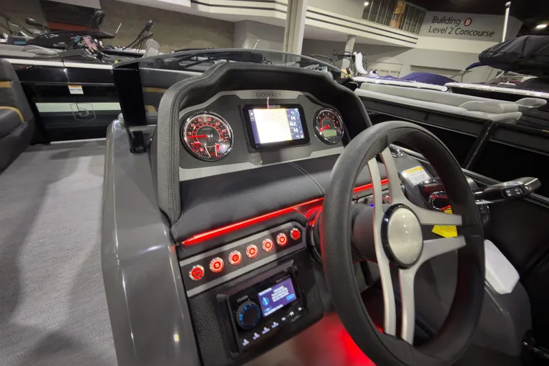Slide: The Image of Interior dashboard of 2026 Godfrey Monaco 255 Ultra Lounge boat, featuring modern controls and steering. - 13