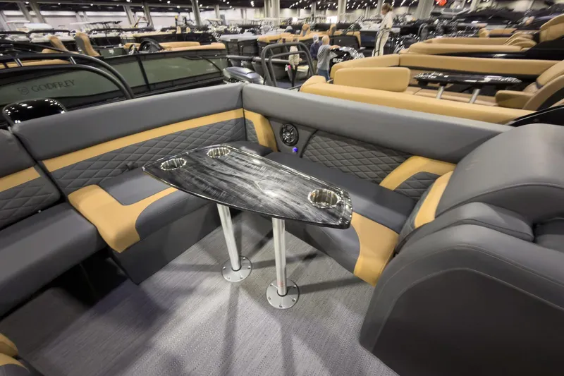 Slide: The Image of Luxurious seating area on 2026 Godfrey Monaco 255 Ultra Lounge boat with sleek table design. - 22