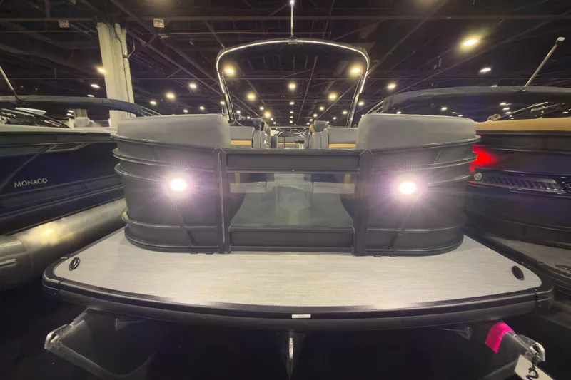 Slide: The Image of 2026 Godfrey Monaco 255 Ultra Lounge pontoon boat displayed indoors with illuminated deck lights. - 4