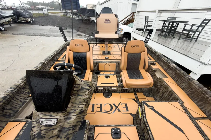 Slide: The Image of 2026 Excel EX203C Crappie & Bass boat with tan and black seating, camo accents. - 13
