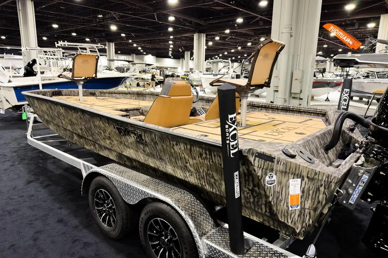 Slide: The Image of 2026 Excel EX203C Crappie & Bass boat on display at an indoor exhibition. - 2