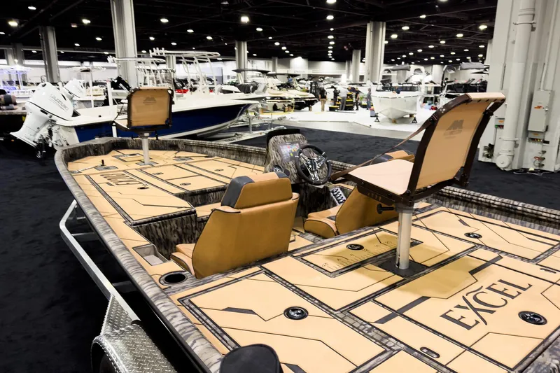 Slide: The Image of 2026 Excel EX203C Crappie & Bass boat displayed at an indoor boat show. - 4