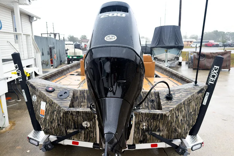 Slide: The Image of 2026 Excel EX203C Crappie & Bass boat with powerful engine, camo design, and trailer. - 8
