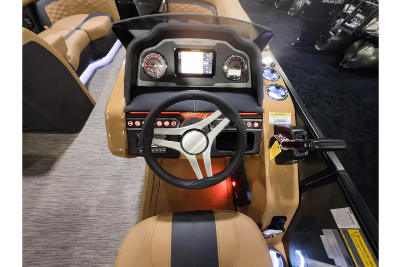 Slide: The Image of 2026 Godfrey Monaco 255 boat dashboard with steering wheel and control panel. - 11