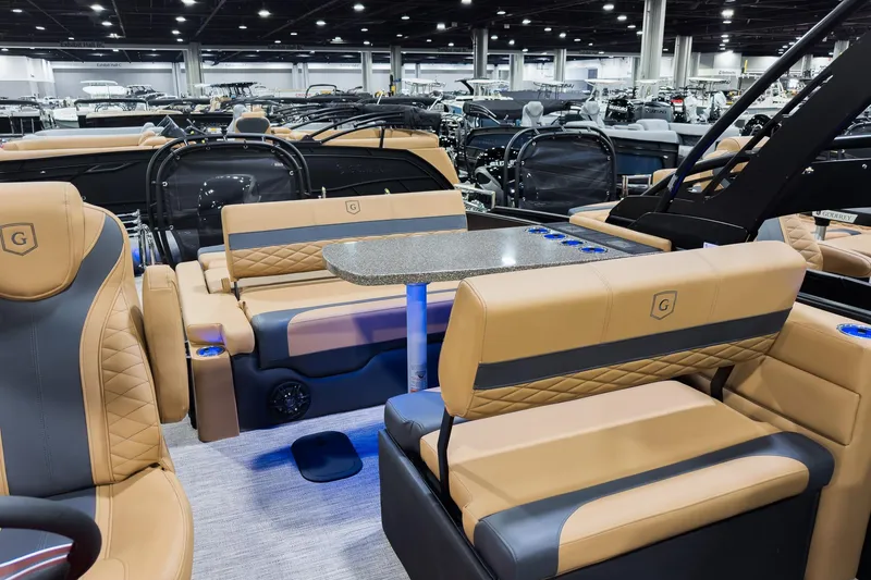 Slide: The Image of Luxurious 2026 Godfrey Monaco 255 boat interior with tan seating and mid-table lounge. - 16