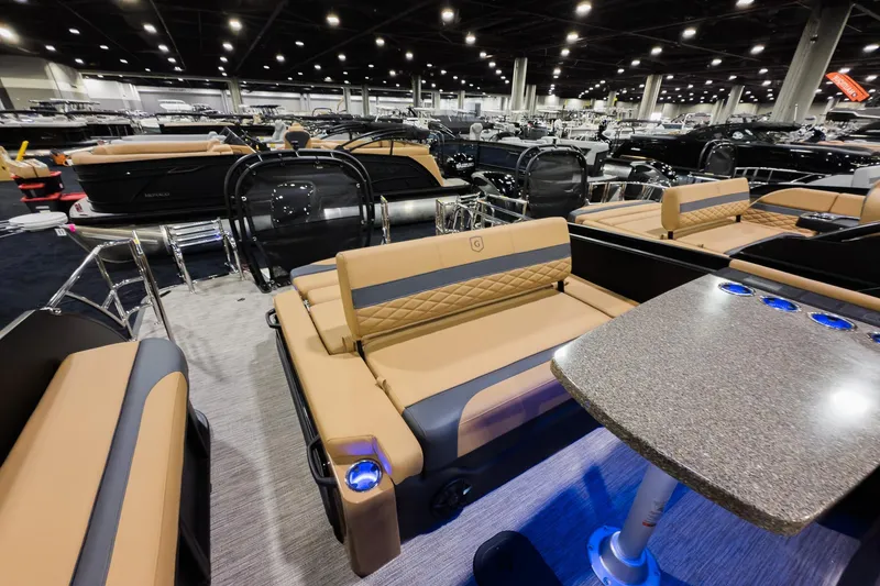 Slide: The Image of Luxurious 2026 Godfrey Monaco 255 boat interior with elegant seating and table at a showroom. - 20