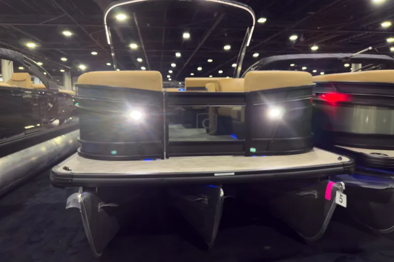 The Image of 2026 Godfrey Monaco 255 pontoon boat with lights at a boat show display. - 0