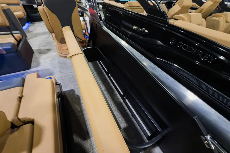 Slide: The Image of 2026 Godfrey Monaco 255 boat interior with tan seating and sleek black exterior. - 27