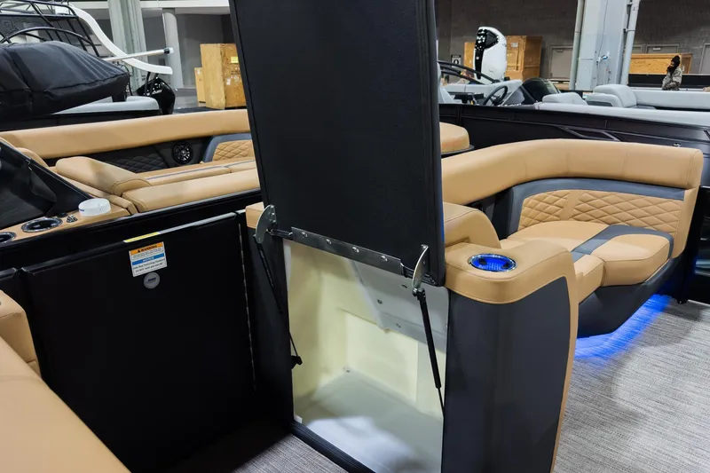 Slide: The Image of 2026 Godfrey Monaco 255 boat interior with tan seating and flip lounge table. - 29