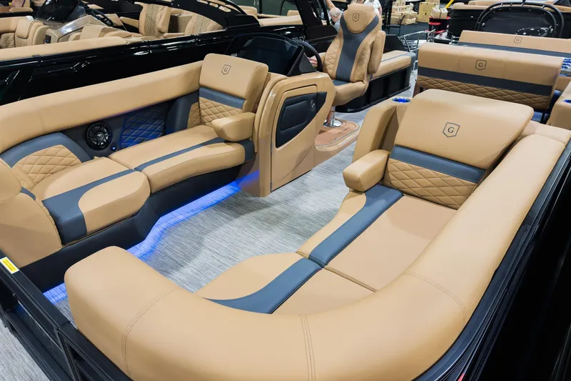 Slide: The Image of Luxurious interior of 2026 Godfrey Monaco 255 pontoon boat with tan and blue seating. - 6