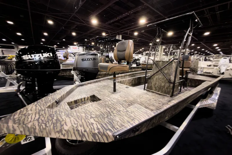 Slide: The Image of 2026 Excel 216 Stalker Center Console boat with Suzuki engines on display indoors. - 10