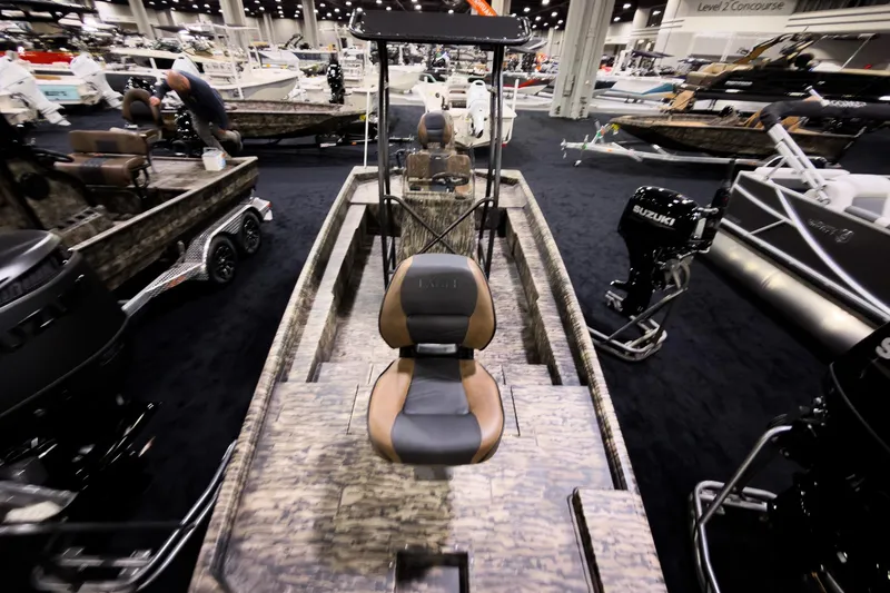 Slide: The Image of 2026 Excel 216 Stalker Center Console boat displayed at an indoor boat show. - 12