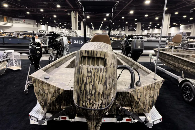 Slide: The Image of 2026 Excel 216 Stalker Center Console boat displayed at an indoor exhibition. - 2