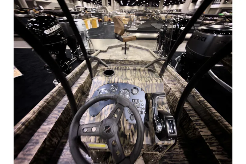 Slide: The Image of 2026 Excel 216 Stalker Center Console boat interior with steering wheel and controls. - 6