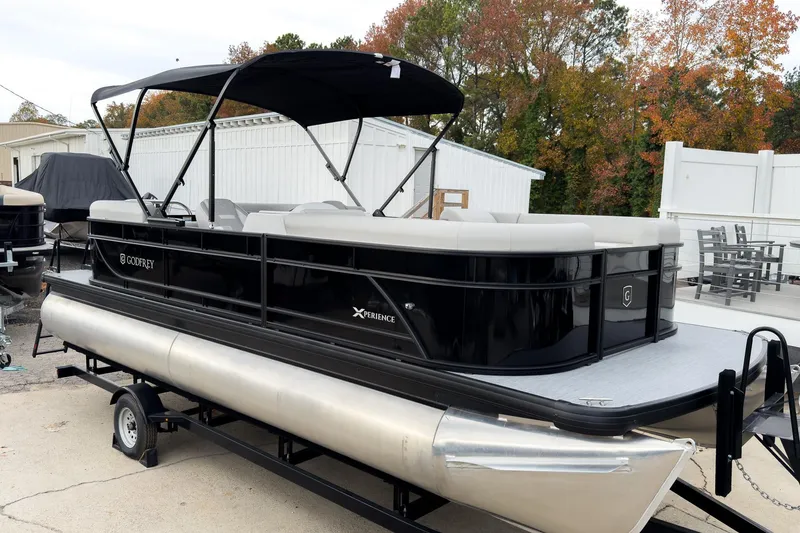 Slide: The Image of 2026 Godfrey Sweetwater Xperience 20' Split Bench Pontoon, black exterior, parked outdoors. - 2