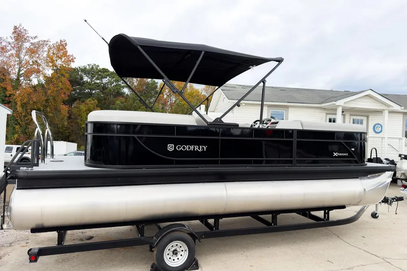 Slide: The Image of 2026 Godfrey Sweetwater Xperience 20' Split Bench Pontoon, black exterior, parked on trailer. - 23