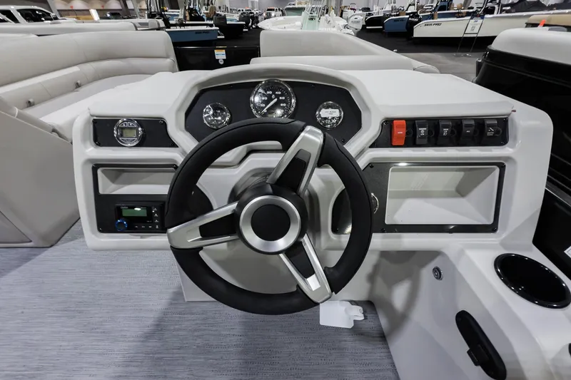Slide: The Image of 2026 Godfrey Sweetwater Xperience 20' pontoon boat dashboard with steering wheel and controls. - 36