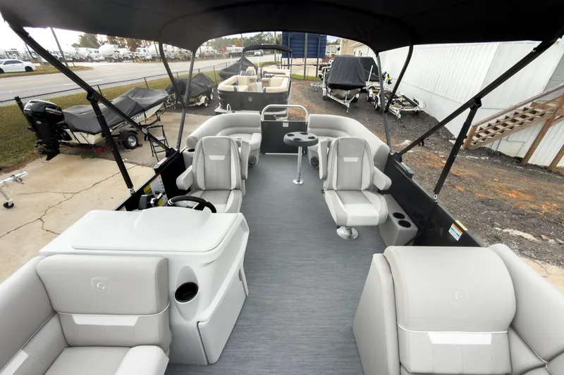 Slide: The Image of 2026 Godfrey Sweetwater Xperience 20' pontoon boat with split bench seating, docked outdoors. - 6