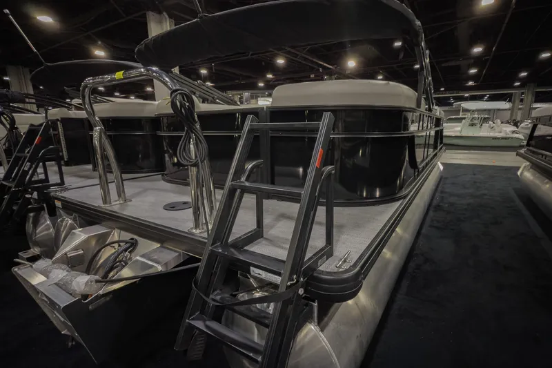 Slide: The Image of 2026 Godfrey Sweetwater Xperience 20' Split Bench Pontoon, showcased indoors with sleek design. - 24