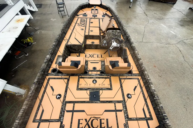 Slide: The Image of 2026 Excel EX203C Crappie & Bass boat with tan and black interior design. - 14