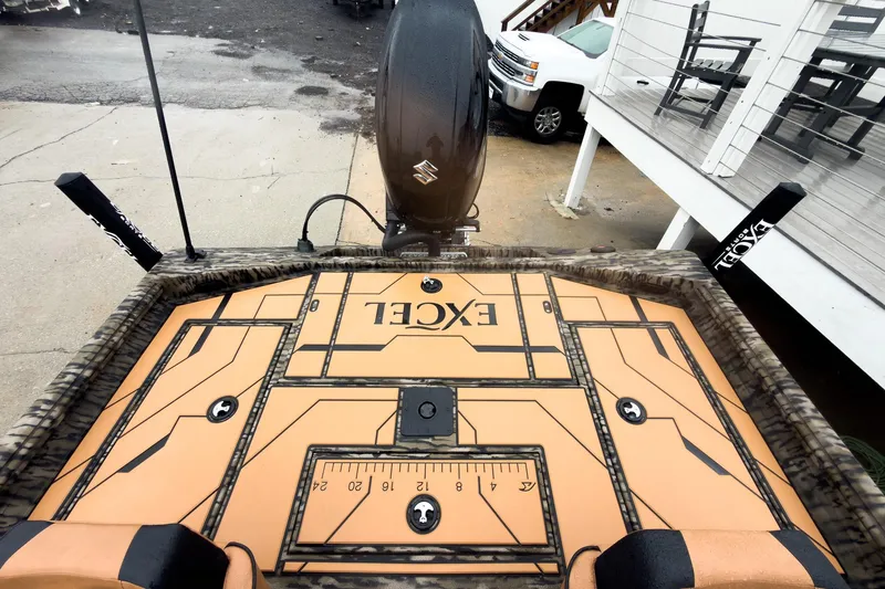 Slide: The Image of 2026 Excel EX203C Crappie & Bass boat deck with measurement ruler and camo design. - 23