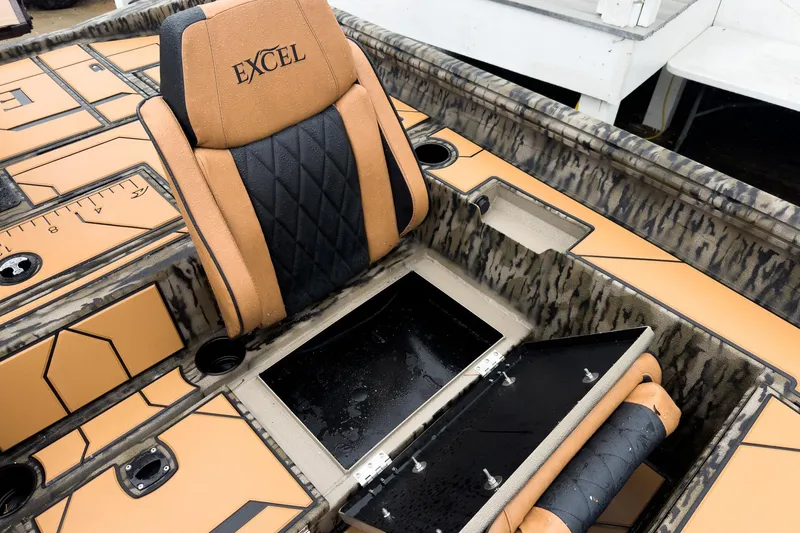 Slide: The Image of 2026 Excel EX203C Crappie & Bass boat interior with storage compartment and cushioned seat. - 28
