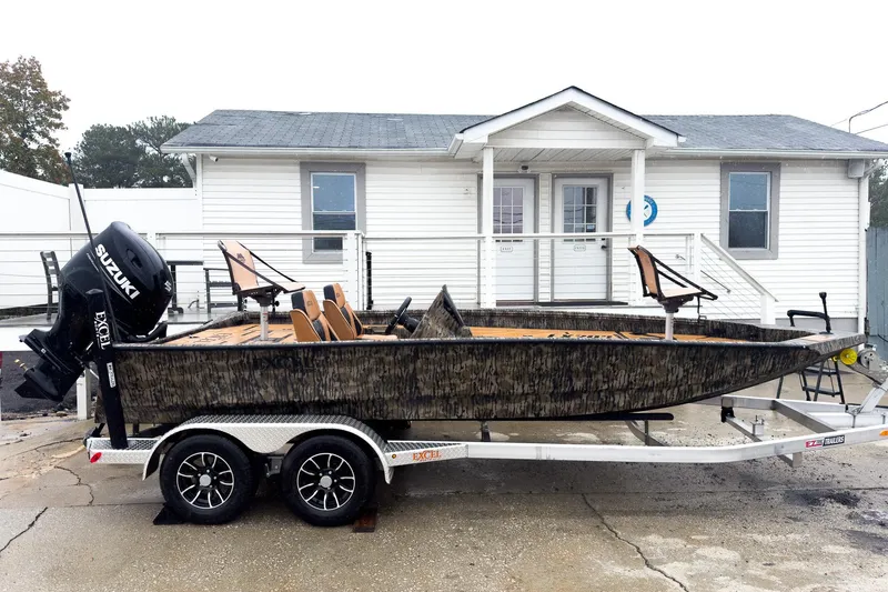 Slide: The Image of 2026 Excel EX203C Crappie & Bass boat on trailer, parked outside a white building. - 5