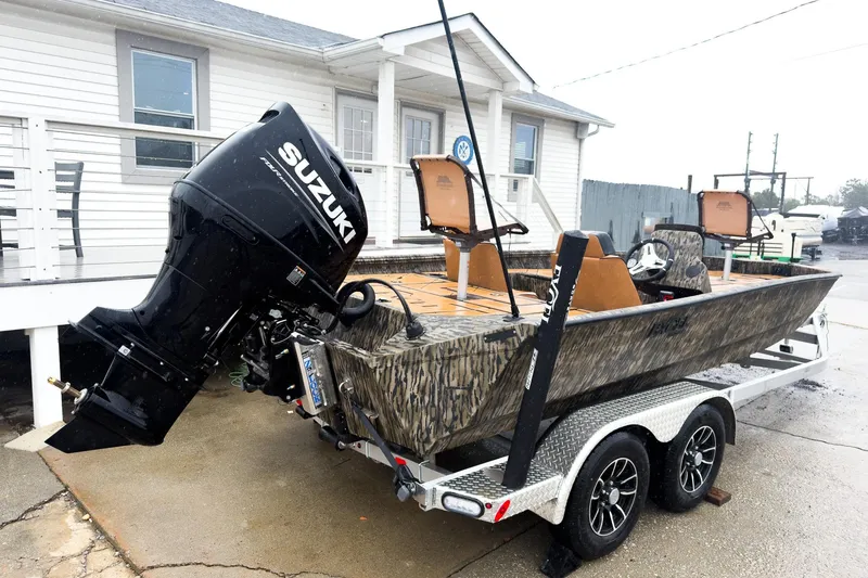 Slide: The Image of 2026 Excel EX203C Crappie & Bass boat with Suzuki motor on trailer, parked outside. - 7