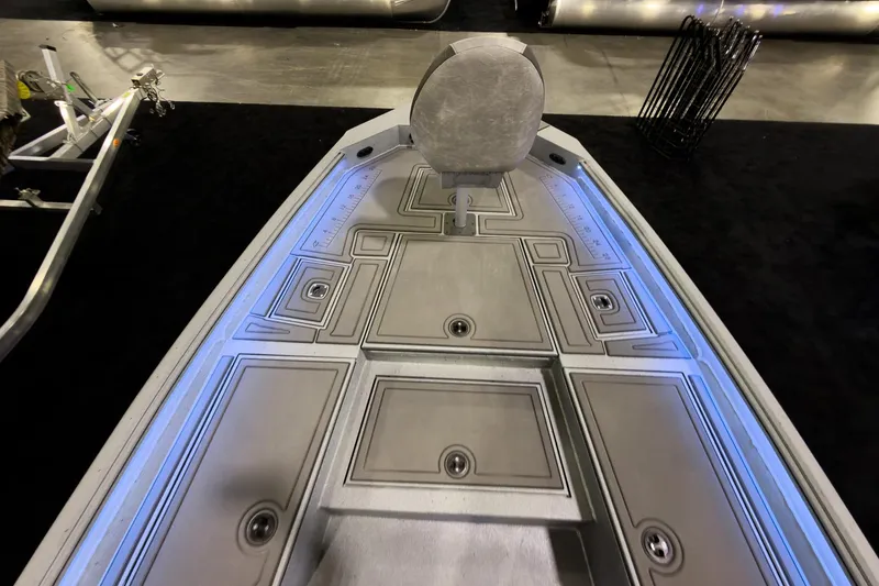 Slide: The Image of 2026 Excel 230 Bay Pro Elite boat deck with seating and storage compartments. - 11