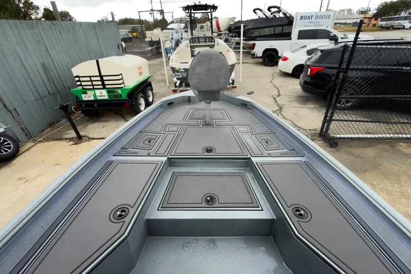 Slide: The Image of 2026 Excel Bay Pro Elite 230 boat deck, featuring sleek design and storage compartments. - 23