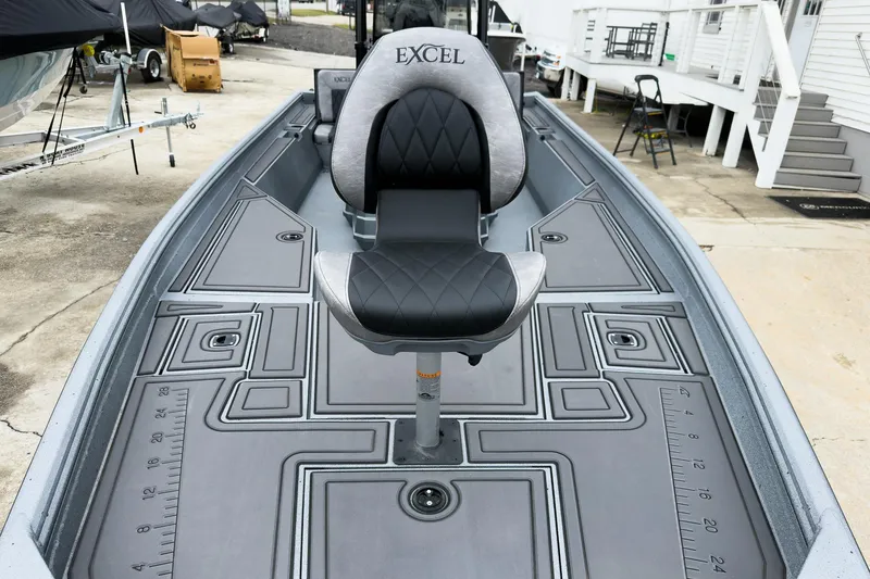 Slide: The Image of 2026 Excel Bay Pro Elite 230 boat interior with cushioned seat and detailed deck design. - 29