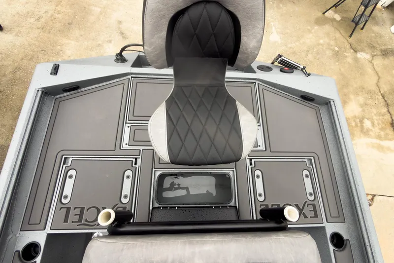 Slide: The Image of 2026 Excel Bay Pro Elite 230 boat deck with seating and storage compartments. - 32