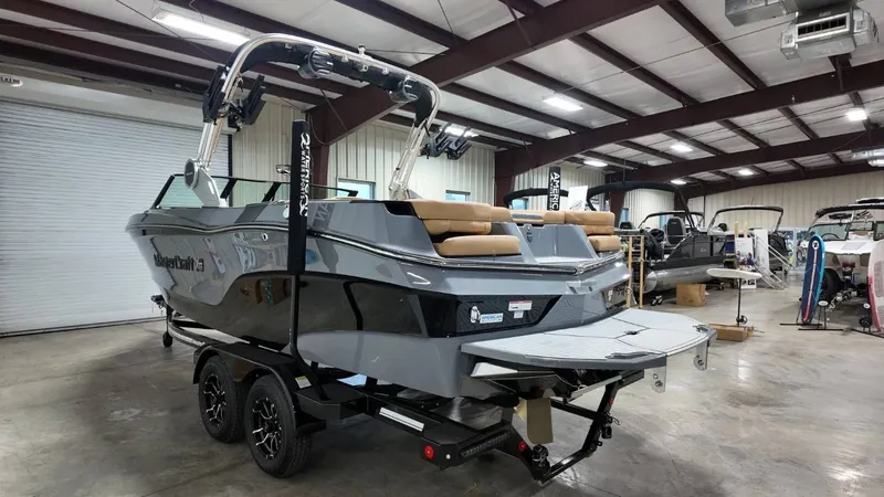 Slide: The Image of 2026 MasterCraft XT23 boat displayed in a warehouse. - 15