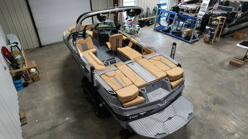 Slide: The Image of 2026 MasterCraft XT23 boat in a workshop. - 16