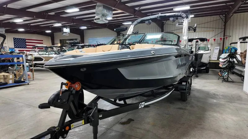 Slide: The Image of 2026 MasterCraft XT23 boat in a warehouse setting. - 17