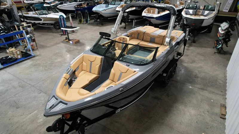 Slide: The Image of 2026 MasterCraft XT23 boat in showroom, luxurious design. - 18
