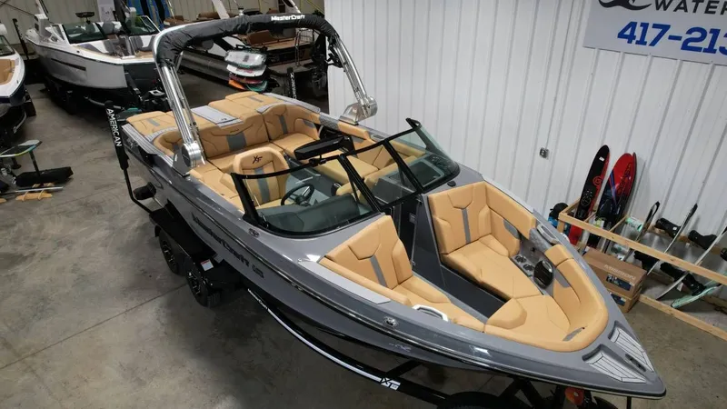 Slide: The Image of 2026 MasterCraft XT23 boat displayed in a showroom. - 20