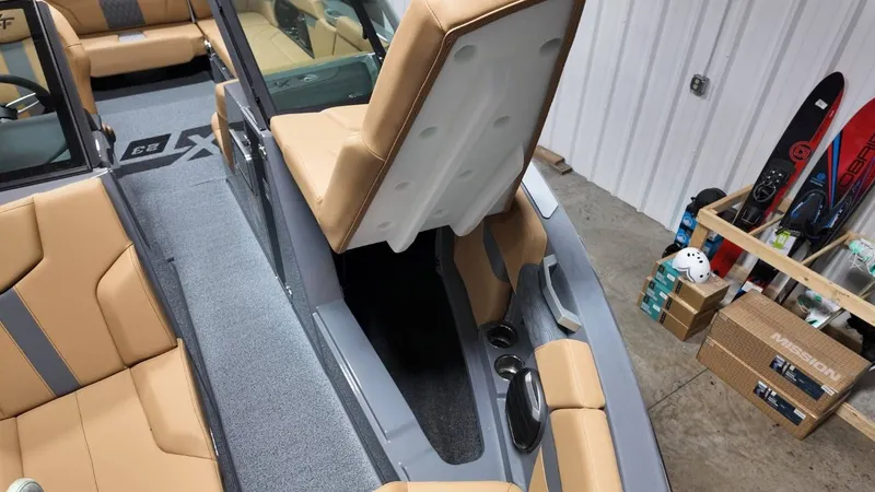 Slide: The Image of Interior of 2026 MasterCraft XT23 boat with beige upholstery. - 25
