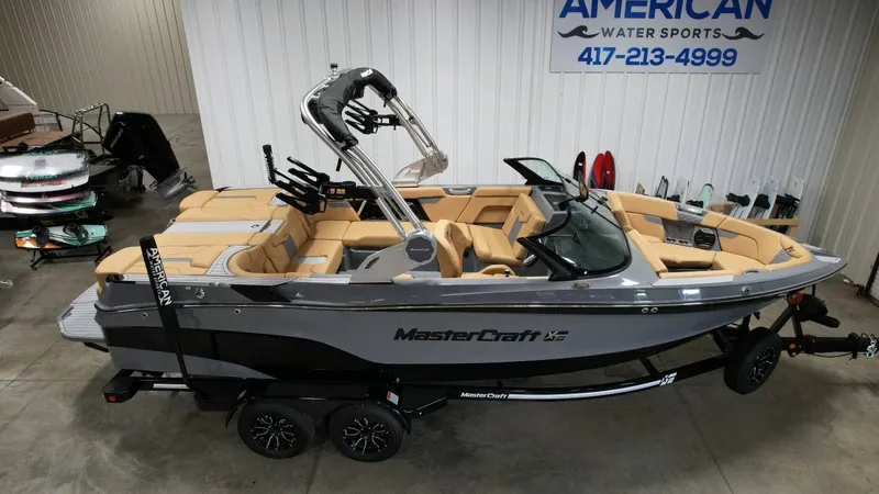 Slide: The Image of 2026 MasterCraft XT23 boat in a showroom. - 3